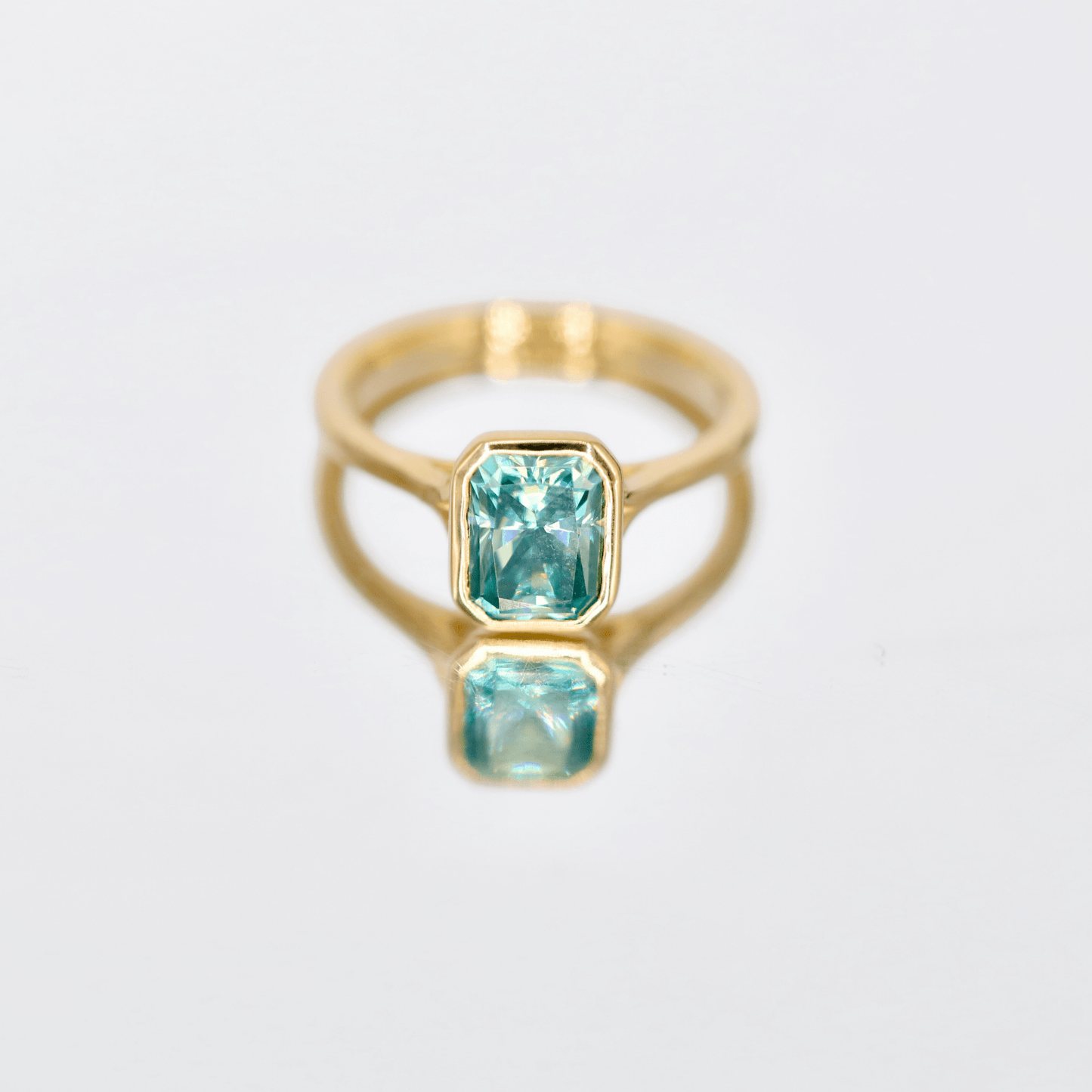 Radiant cut moissanite ring in bezel setting
