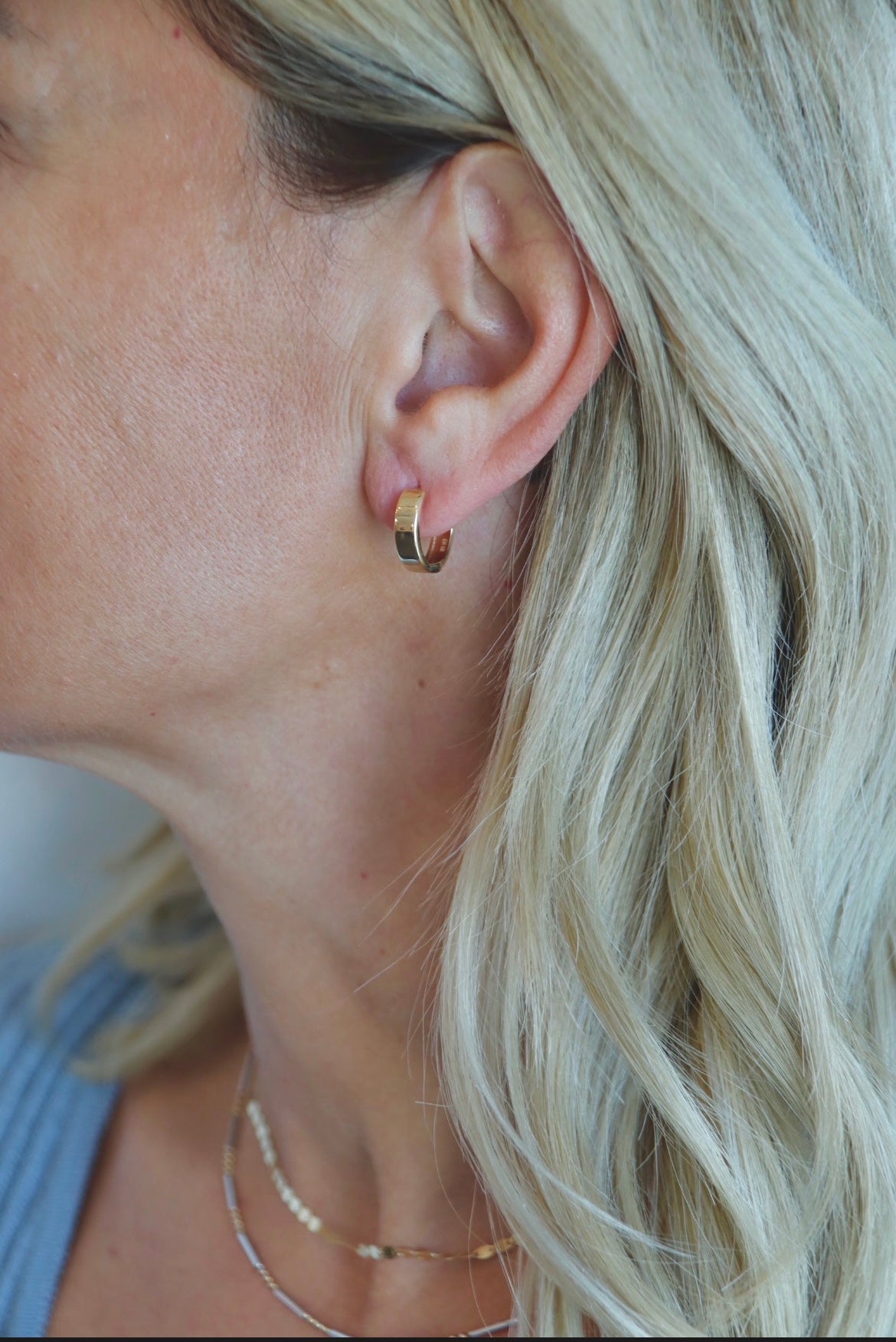 Wearing Edgy Huggie Bold Hoop Earrings