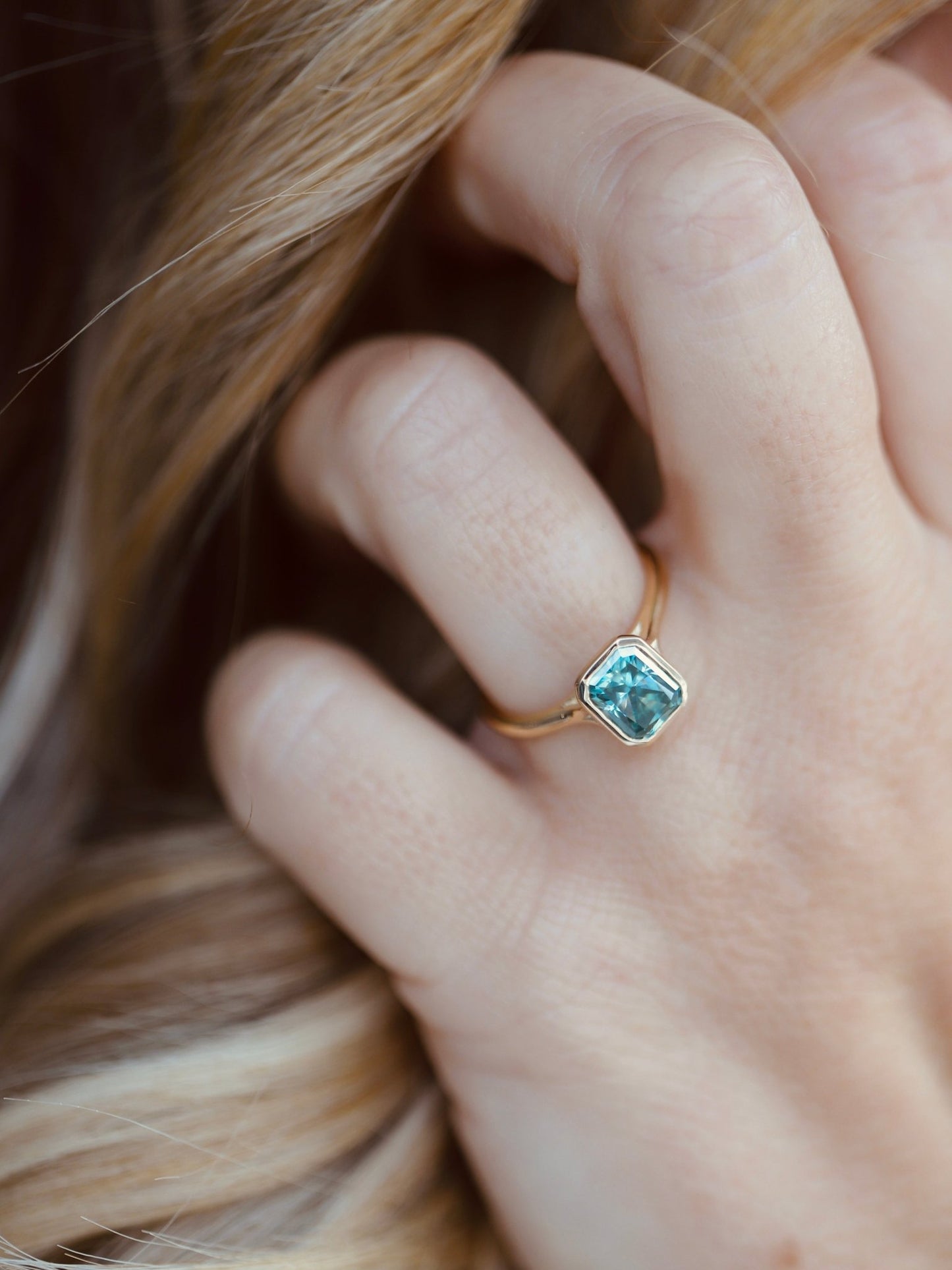 Elegant Lu & Lo Riven ring featuring bezel-set radiant cut moissanite gemstone