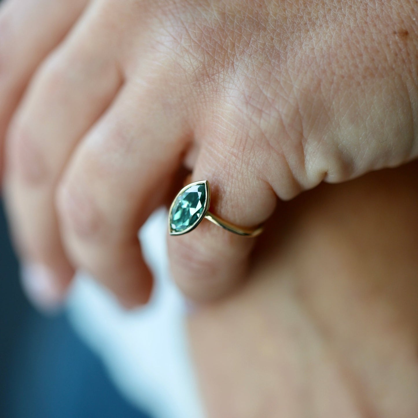 Marquise cut blue-green moissanite ring by Zara in bezel setting,