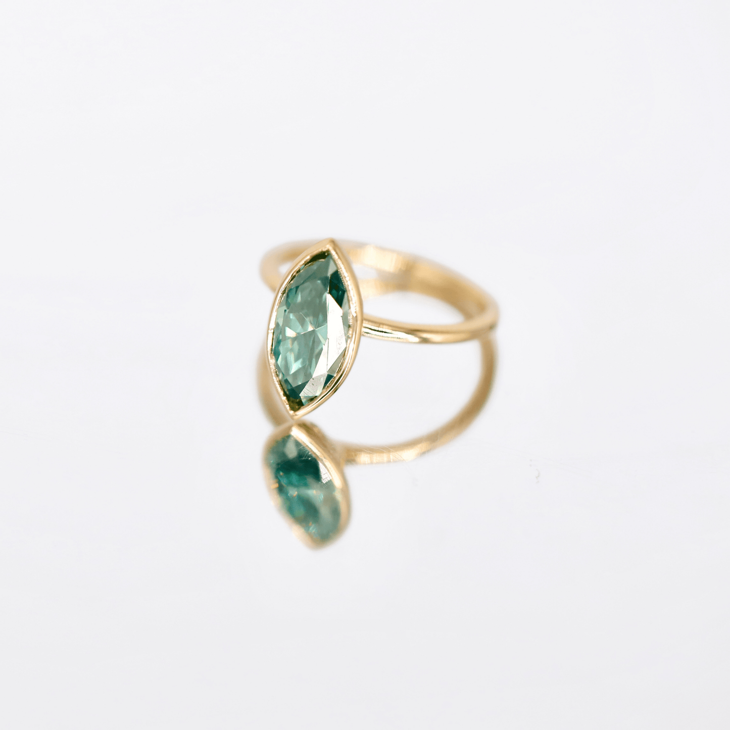 Elegant Zara blue-green moissanite ring bezel-set with marquise cut stone