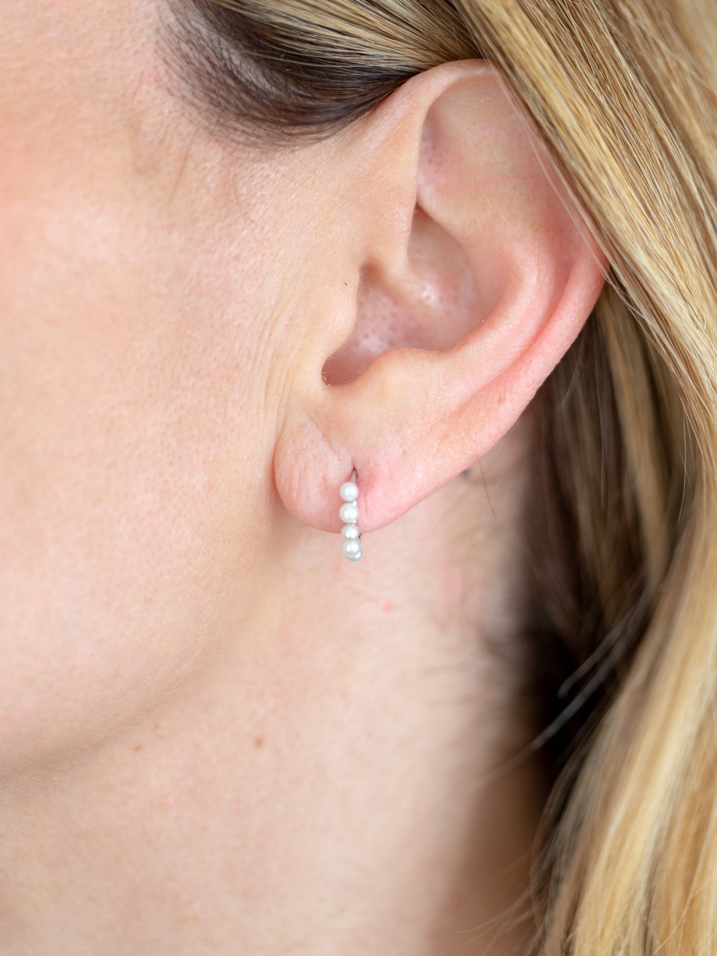 Wearing Mini Pearl Huggies Earrings