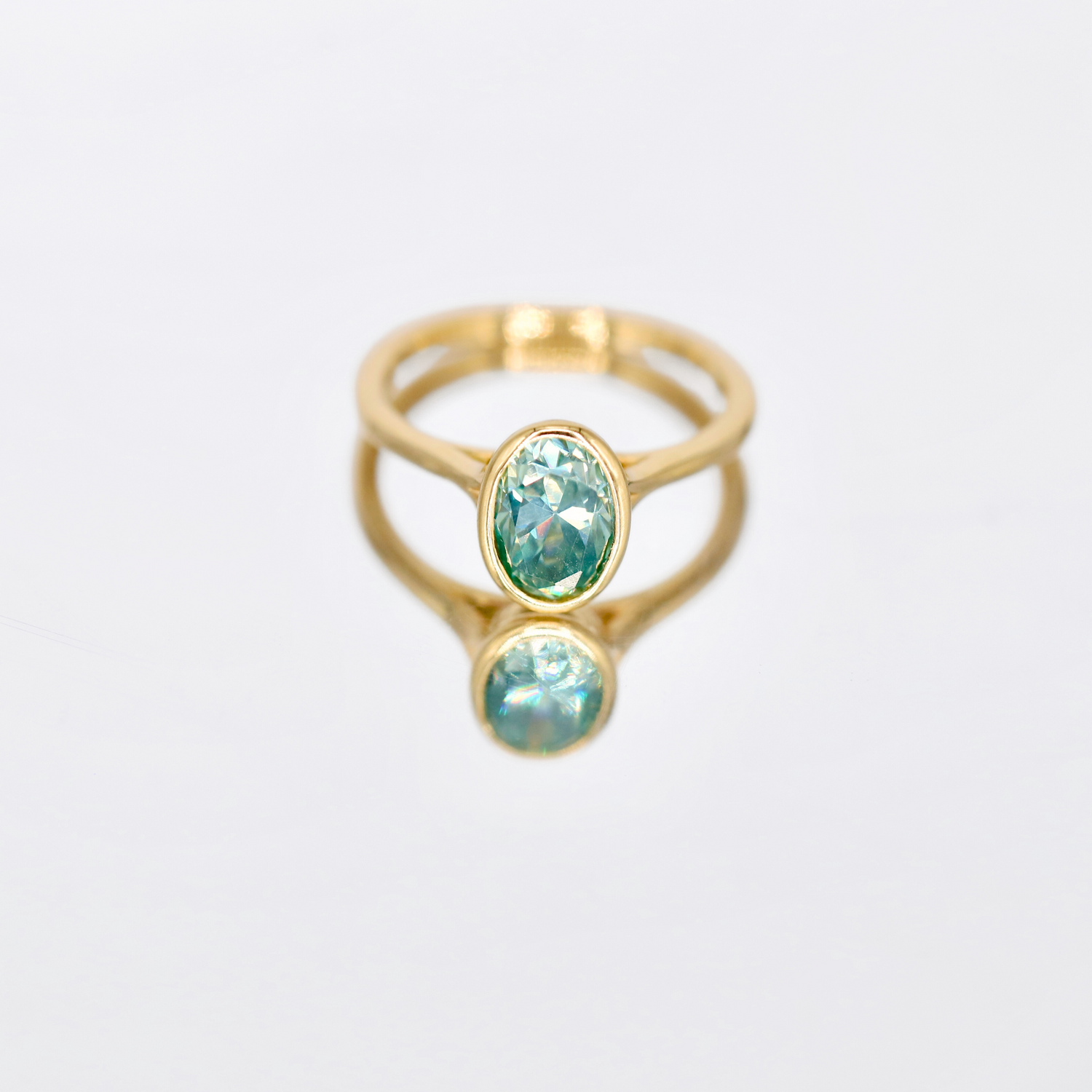 Alina | Bezel-Set Oval Cut Blue Moissanite Ring – Stunning oval cut blue moissanite in a sleek bezel setting. Crafted in solid gold for a modern and elegant look.