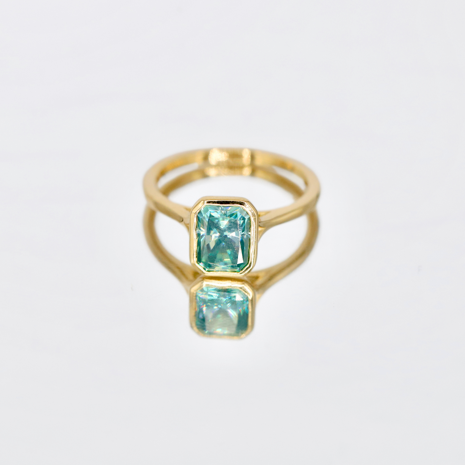 Riven | Bezel-Set Radiant Cut Moissanite Ring – Modern and sleek bezel-set ring featuring a radiant cut moissanite, crafted in solid gold. A timeless engagement or statement ring with a minimalist design